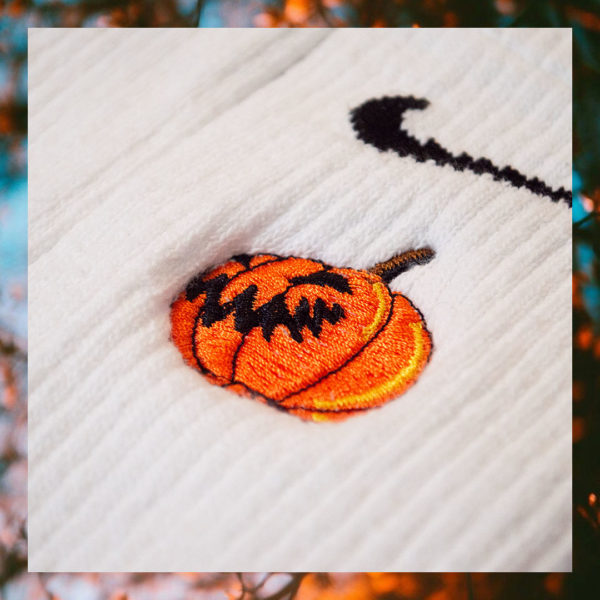 Crew sock featuring an embroidered jack-o'-lantern design from steinblokk's Halloween release